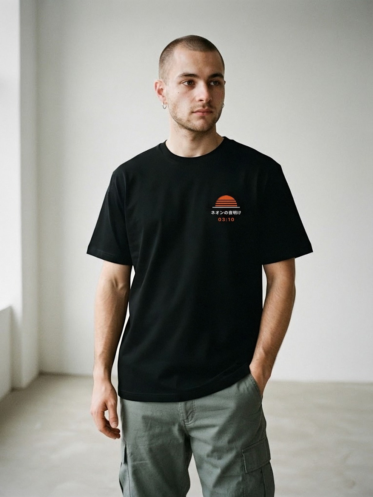 Model wearing the Neon Dawn Shuya Eigyo 終夜営業 black tee, front view with the embroidered 03:10 Neon Dawn sun on the chest