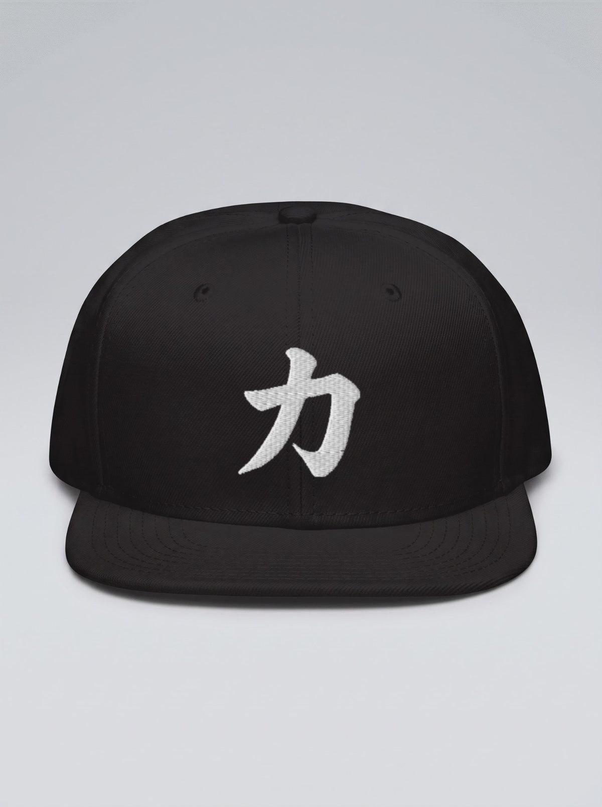 Osaka Chikara 力 Fude Edition snapback in black, front view — white brush-stroke kanji embroidery on a grey studio backdrop