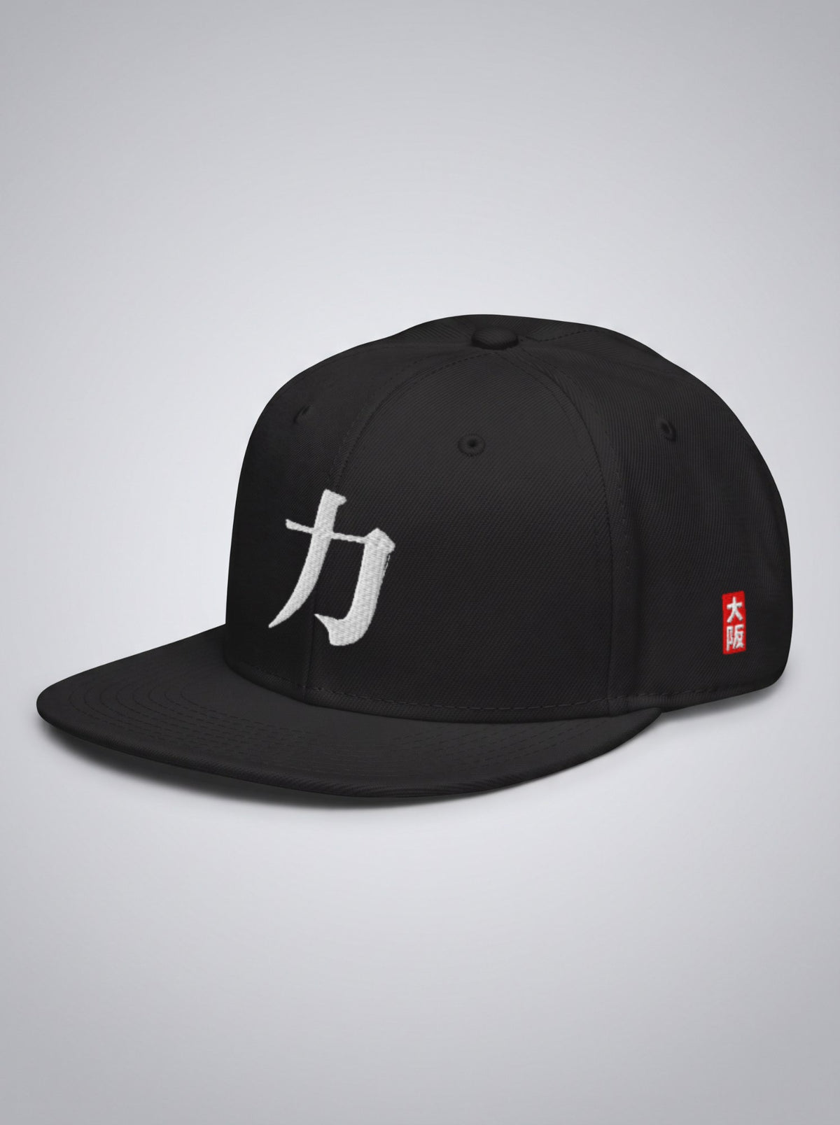 Hanko Edition snapback in black, three-quarter view with the red 大阪 seal on the side