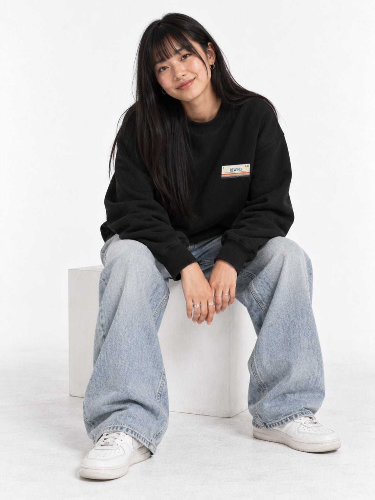 Kasetto カセット C-60 Japanese Tape Label Sweatshirt in black by 5C5V, on model, seated