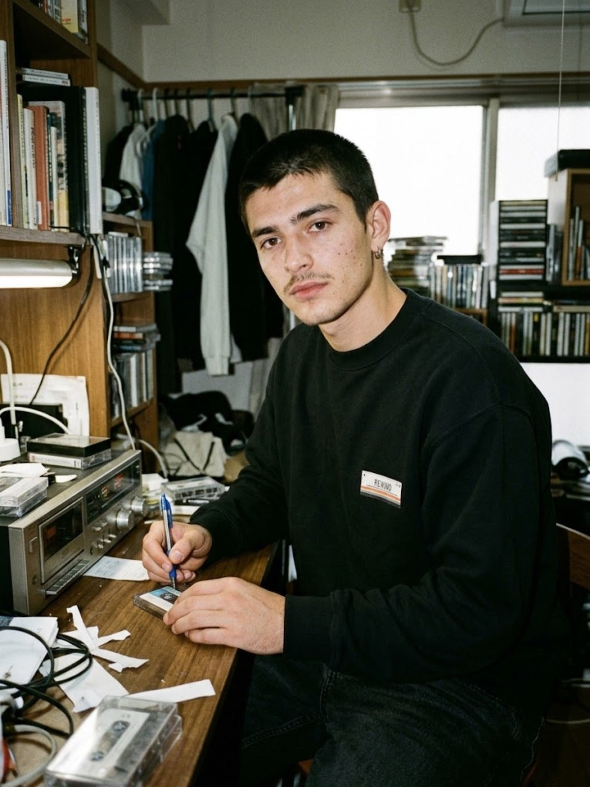 Kasetto カセット C-60 Japanese Tape Label Sweatshirt by 5C5V labelling a cassette at a desk