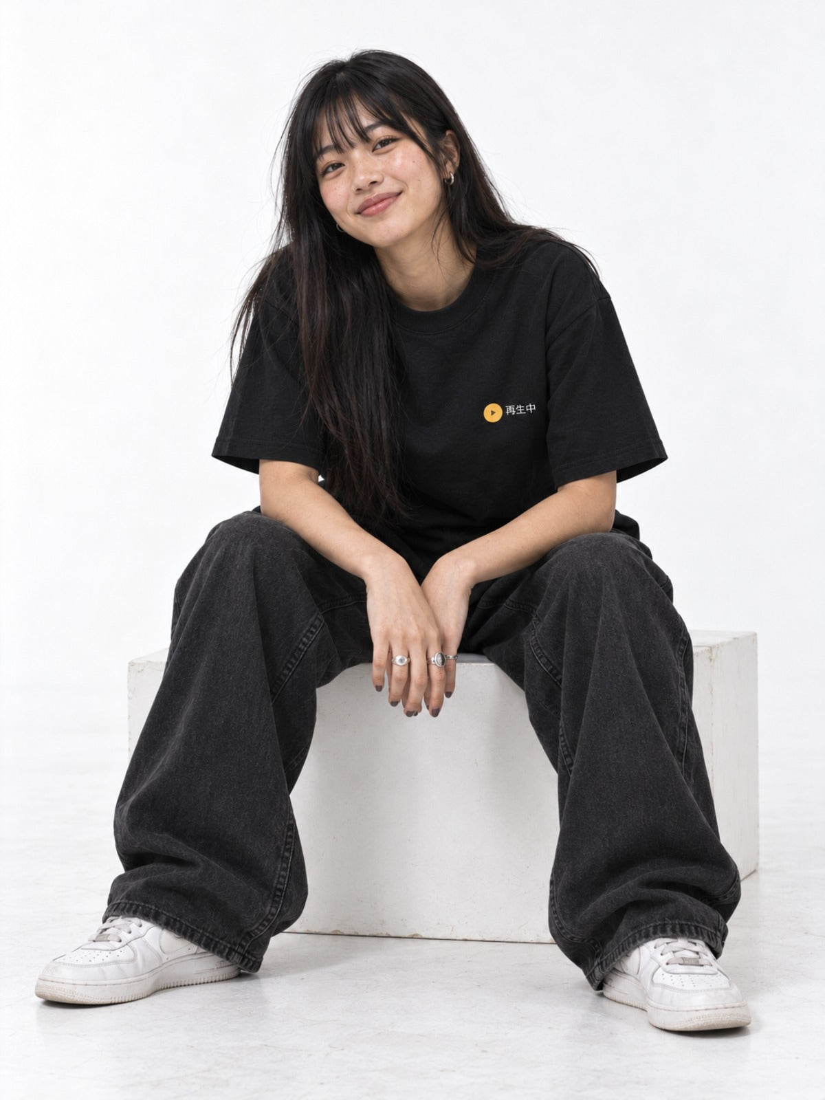 Saisei-chū 再生中 Japanese Cassette Player T-Shirt in black by 5C5V, on model, seated