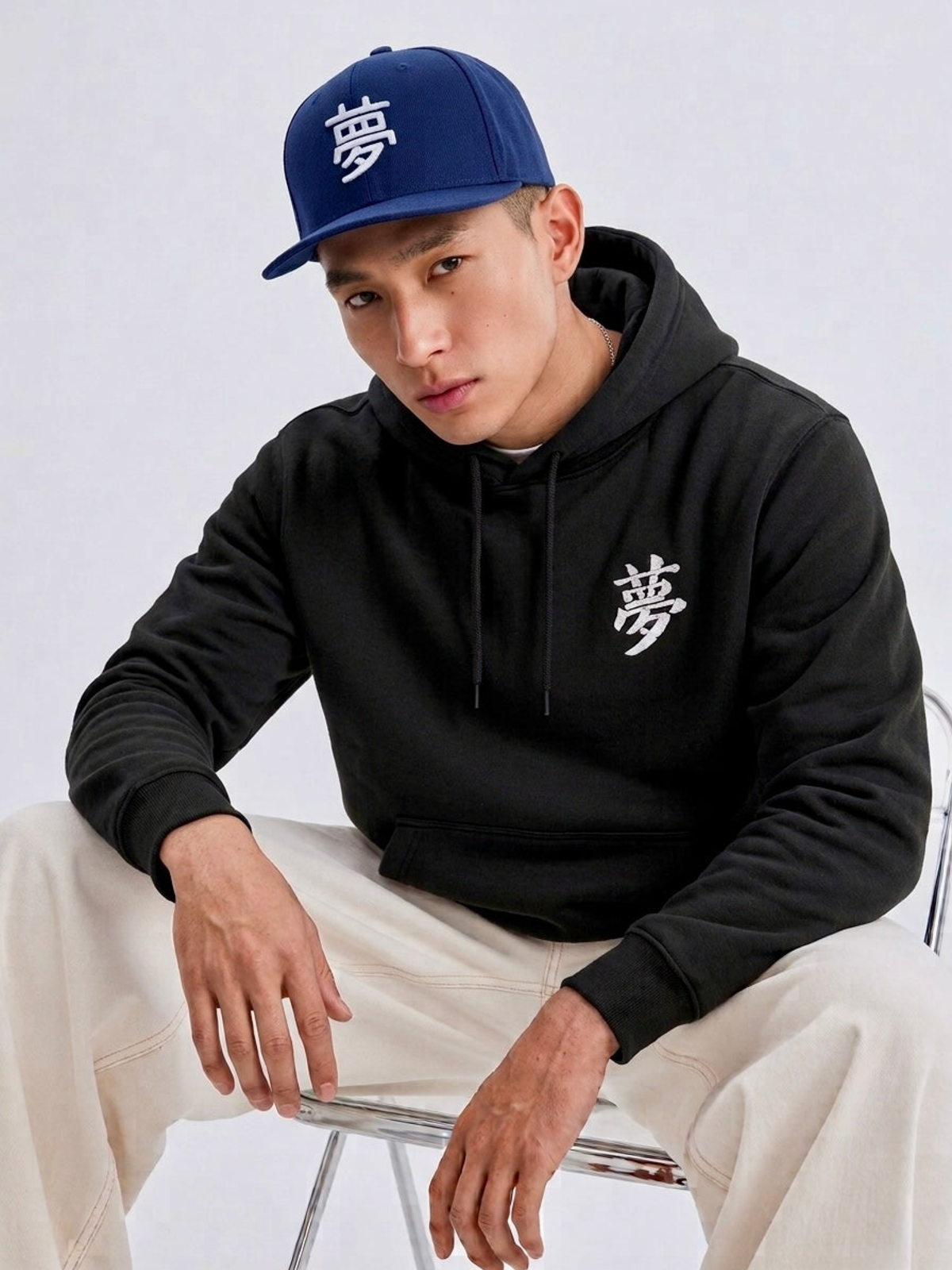 Model in a black hoodie wearing the navy Tokyo Dream 夢 snapback